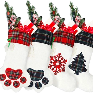 Four-piece set of plaid Christmas stockings with plush trim, pet paws, and snowflake designs