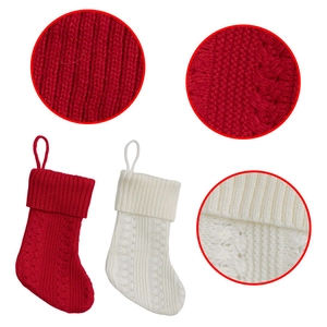 Close-up of red and white knitted Christmas stockings with detailed cable stitch texture