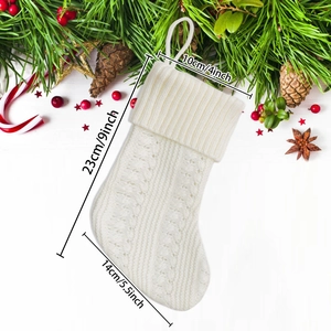 Detailed knit pattern on a white Christmas stocking with size dimensions displayed