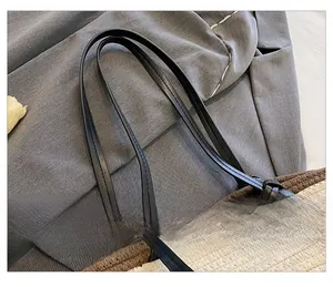 Detail of woven tote bag showing black leather straps and precise knotting craftsmanship