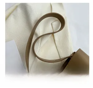 Detail view of brown leather shoulder bag showing flexible strap and fine stitching work