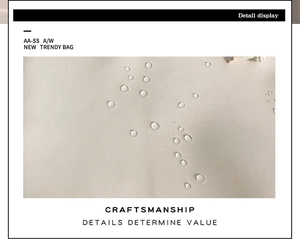 Detail shot of the beige water-resistant fabric with clear beads on a travel backpack