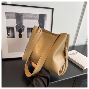Detailed view of khaki leather tote bag featuring matte finish and premium stitching