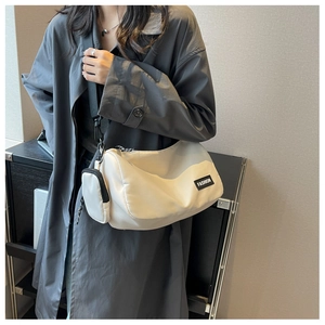 Detailed shot of white nylon pillow bag with detachable coin purse and fashion patch