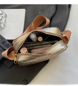 Internal view of gold textured crossbody bag showing spacious capacity for phone and cosmetics