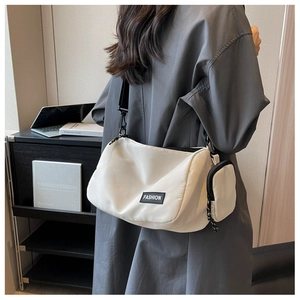 Detail of off-white nylon crossbody bag with mini coin purse and FASHION rubber label