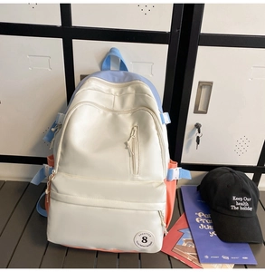 Detail of multi-color nylon backpack with spacious compartments and pastel side pockets