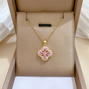 Macro shot of titanium steel clover necklace with pink gems and zircon inlay in box