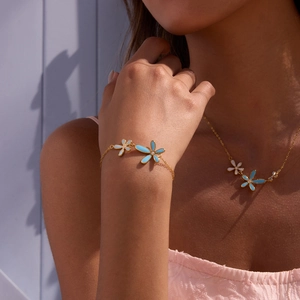 Floral 18K gold plated jewelry set with blue enamel flowers and sparkling zircon accents