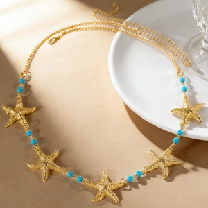 Goldene Seestern-Taillenkette mit türkisen Perlen für den Strandurlaub im Boho-Stil