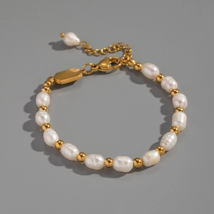 Macro detail of natural freshwater baroque pearls and gold plated stainless steel beads
