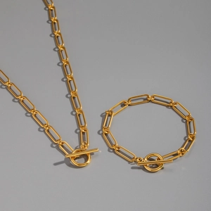 Detail of gold paperclip chain necklace and bracelet set with T-bar OT toggle closure