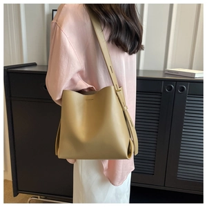 Detailed view of khaki large capacity bucket bag with adjustable strap and matte finish