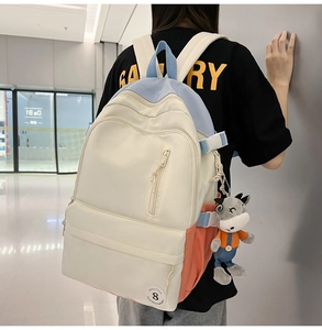 Close-up of model wearing the large capacity multi-pocket canvas backpack with cow charm