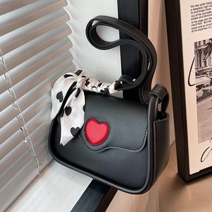 Stylish black mini handbag with red heart detail and heart-print scarf handle
