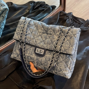 Quilted denim chain bag with blue tweed texture and metallic logo twist-lock closure