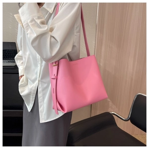 Adjustable gold-tone buckle detail on large pink tote bag with matte leather texture