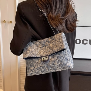 Navy denim quilted chain bag with silver lock and crossbody strap for women