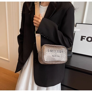 Detail of glitter crossbody bag with wide strap and SMILEDT Bag Of Paris lettering