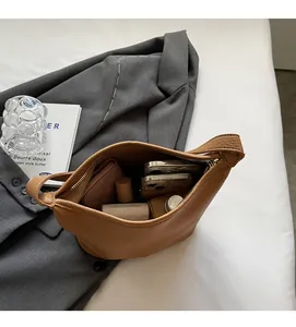 Top-down view of a brown bucket bag showing large interior space for phone and wallet