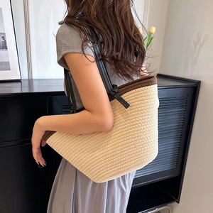 Large woven tote bag in cream and brown with black shoulder straps for summer wear