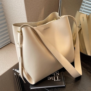 Large beige leather bucket bag for women with premium texture and stylish shoulder strap