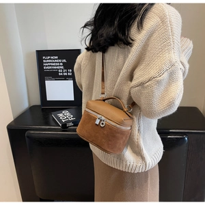 Brown leather textured box bag shown with a model for style and size reference