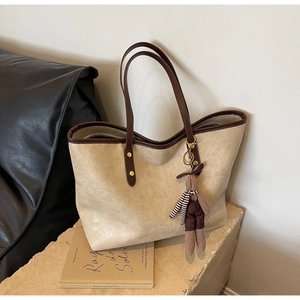 Vue détaillée du sac cabas crème avec texture grainée et charmant lapin en peluche