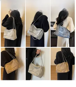Detail view of large chain tote bags with marble texture and silver hardware in three colors