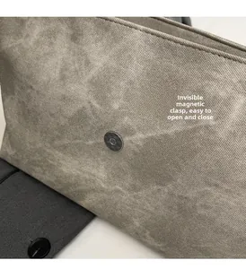 Detail of grey washed fabric bag featuring a hidden magnetic buckle for convenient opening