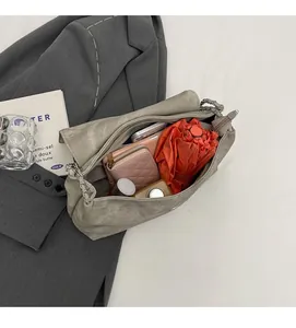 Macro view of large capacity grey chain tote bag showing spacious interior with essentials