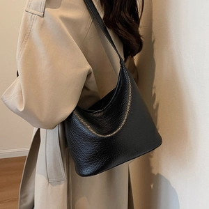 Classic black leather hobo bag with cracked texture shown from a side view on model