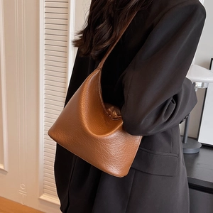 Brown lychee grain leather hobo shoulder bag for women shown in a side-carry view