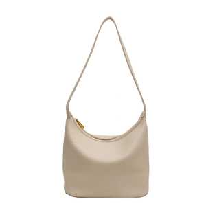 Minimalist beige pebble leather hobo shoulder bag with elegant gold zipper on white background