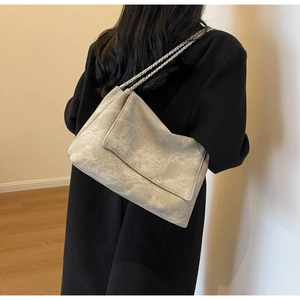 Close-up of gray chain tote bag featuring marble texture and silver metallic strap
