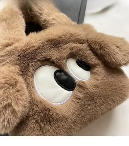 Close-up of fluffy plush dog-shaped tote bag showing soft faux fur and eye embroidery