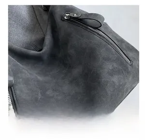 Detail showing the fine suede texture and metal zipper of the vintage grey tote bag