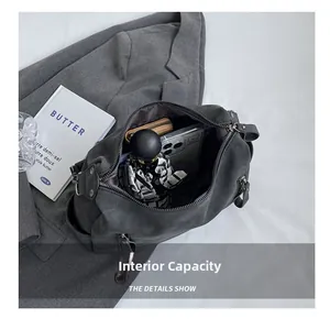 Detail shot showing internal capacity of large grey tote bag with umbrella and phone