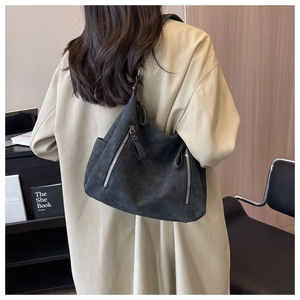 Detail of the large charcoal tote bag showing matte texture and dual vertical zippers