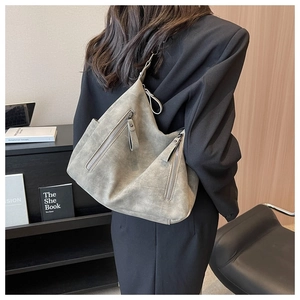 Detailed back view of a grey vintage tote bag with dual zippers worn on shoulder