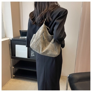 Detailed side view of large grey suede tote bag with zipper pocket and modern minimalist style