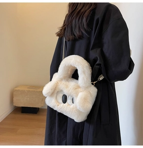 Detail of the soft white plush handbag featuring cute cartoon eyes and fuzzy texture