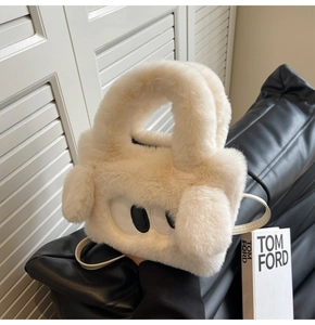 Detail of soft cream plush handbag featuring cute cartoon eyes and long faux fur ears