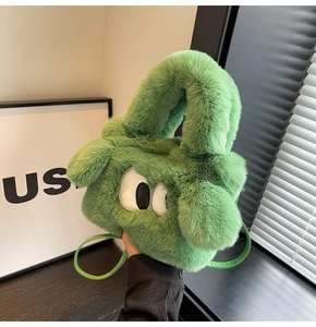 Detail of green fuzzy plush handbag featuring large cartoon eyes and a shoulder strap