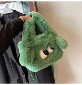 Detail of the grass green plush handbag featuring cartoon eyes and soft furry texture