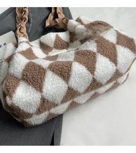 Detail of checkered plush tote bag with brown woven leather handle and soft texture