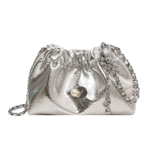 Silver metallic cloud bucket bag with chain strap and pearl pendant on white background