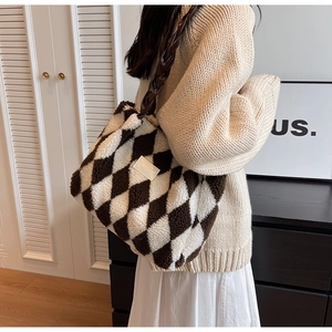 Detail of plush tote bag with brown and white quilted pattern and woven strap