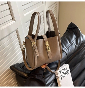 Vue détaillée du sac seau en cuir grainé taupe avec boucle métallique dorée chic