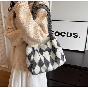 Detail of grey and white checkerboard plush tote with braided leather handles